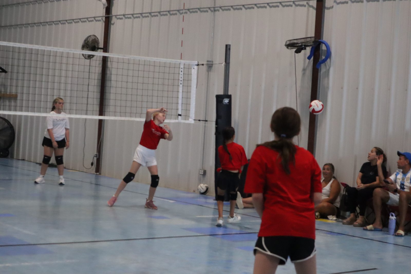 A volleyball rally in play at Next Level Training Academy